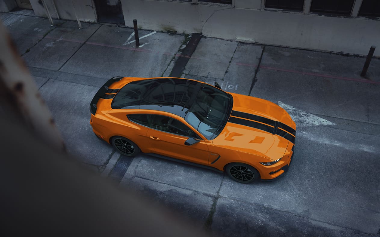 Top image looking down on orange Ford Mustang Shelby GT350