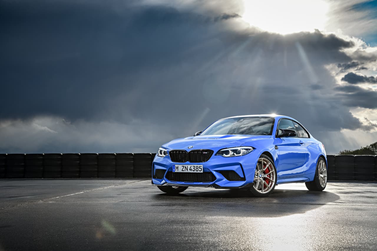Great artistic front image of blue BMW M2 CS with sun shining down