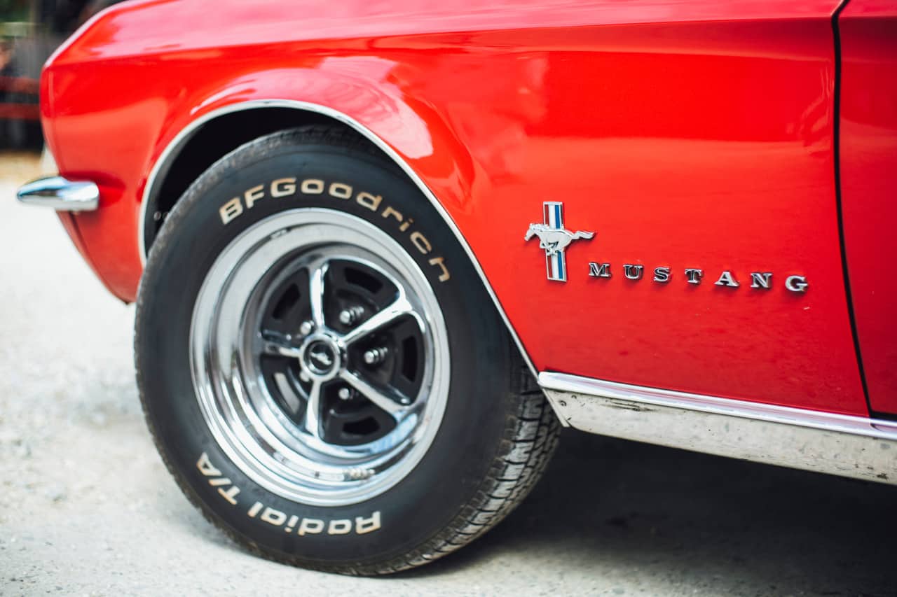 In tight wheel shot of a Ford Mustang vintage car