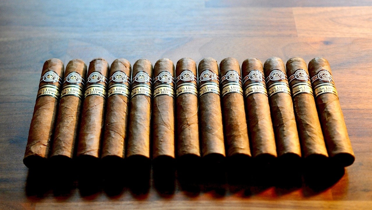 A row of Cuban cigars in need of proper humidification, resting on a wooden table