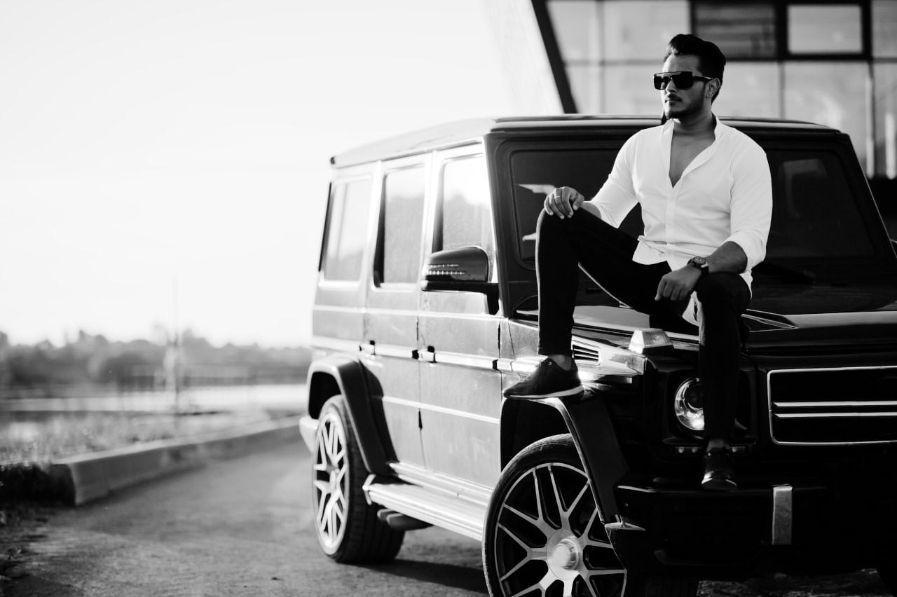 Solid Asian Man In White Shirt And Sunglasses Posed Near Black M