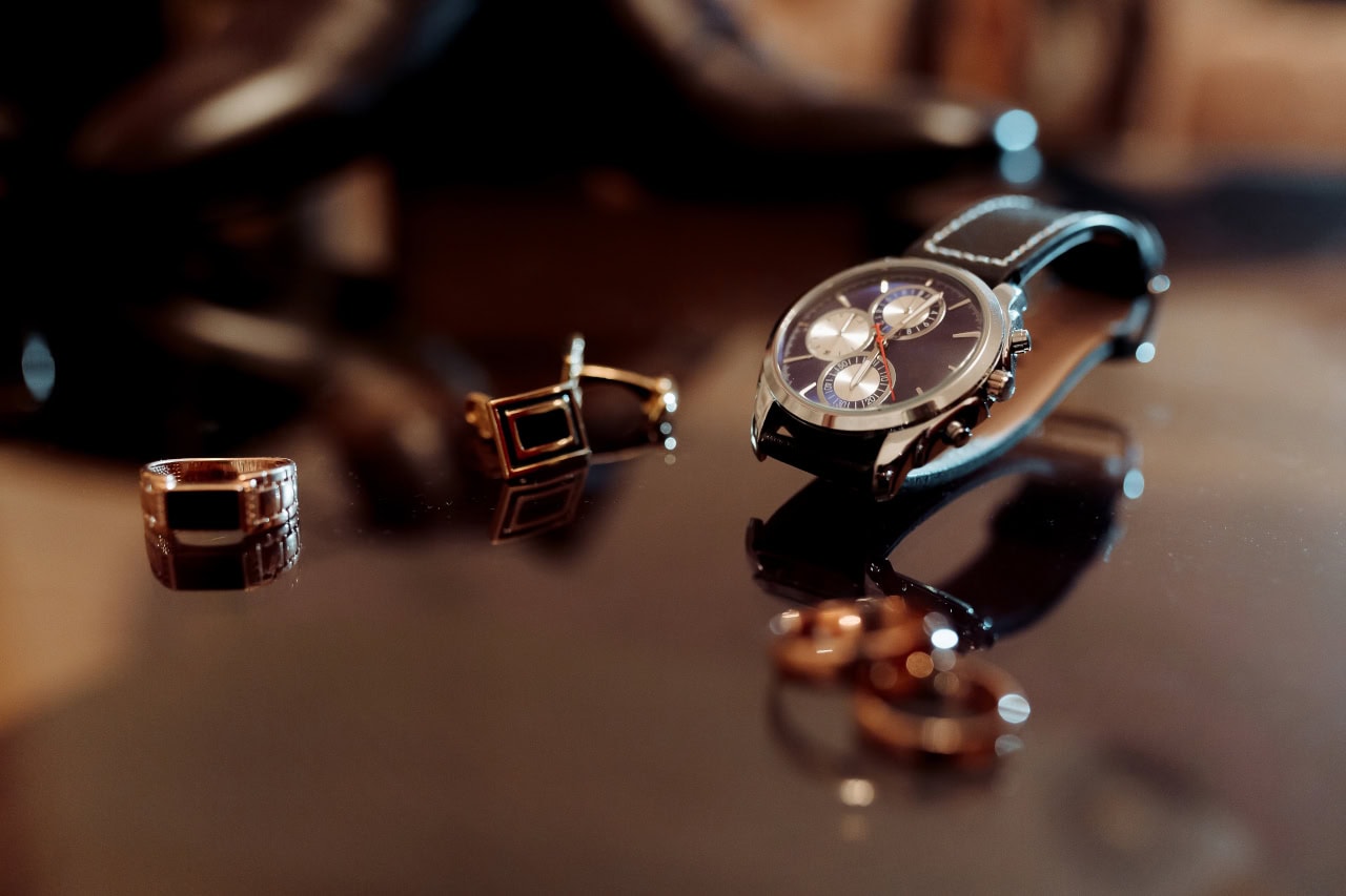 A Watch And A Ring Are On A Table