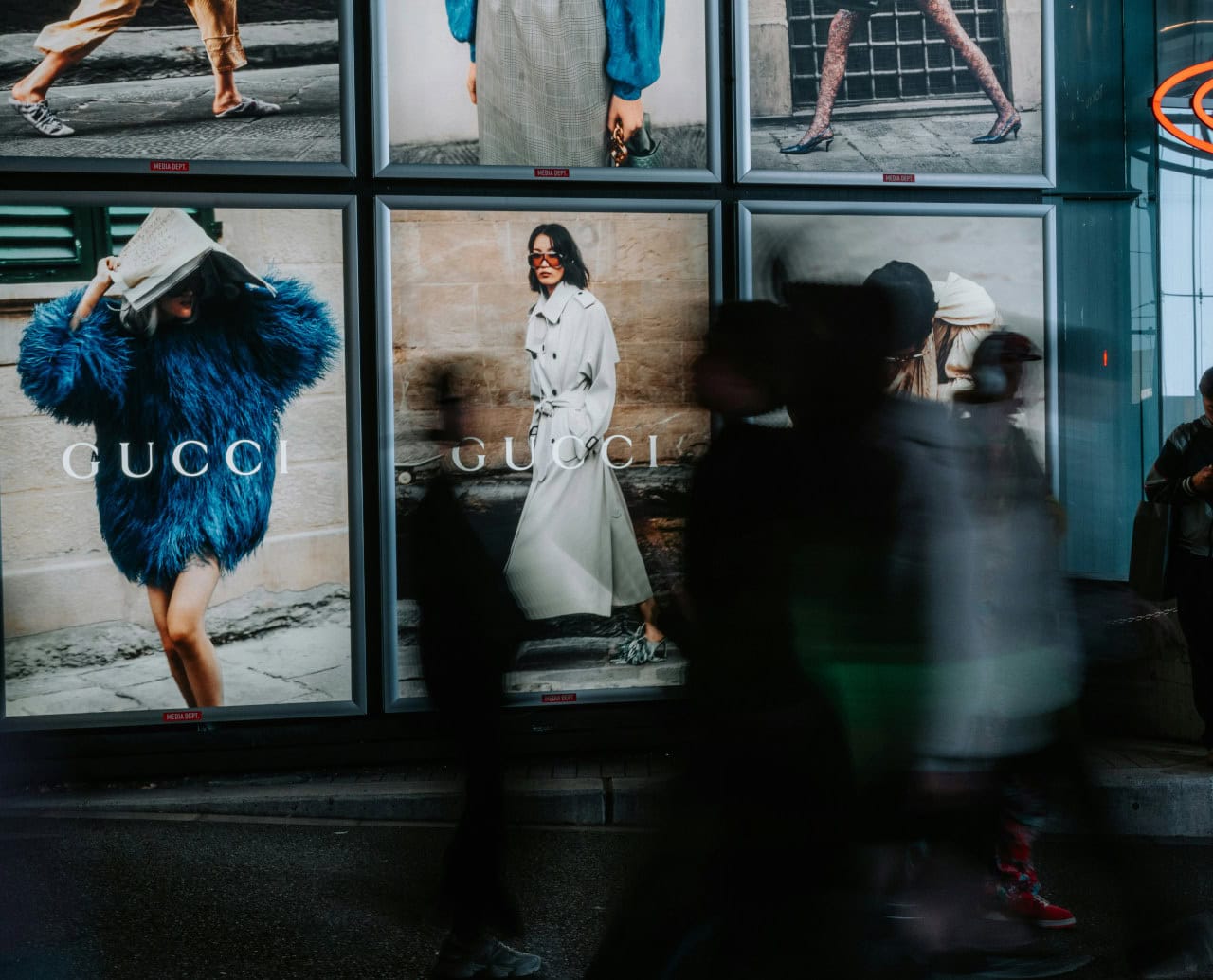 takashi-sakamoto-9iibZM9IOho-unsplash People walking past Gucci advertisement, Takashi Sakamoto, unsplash